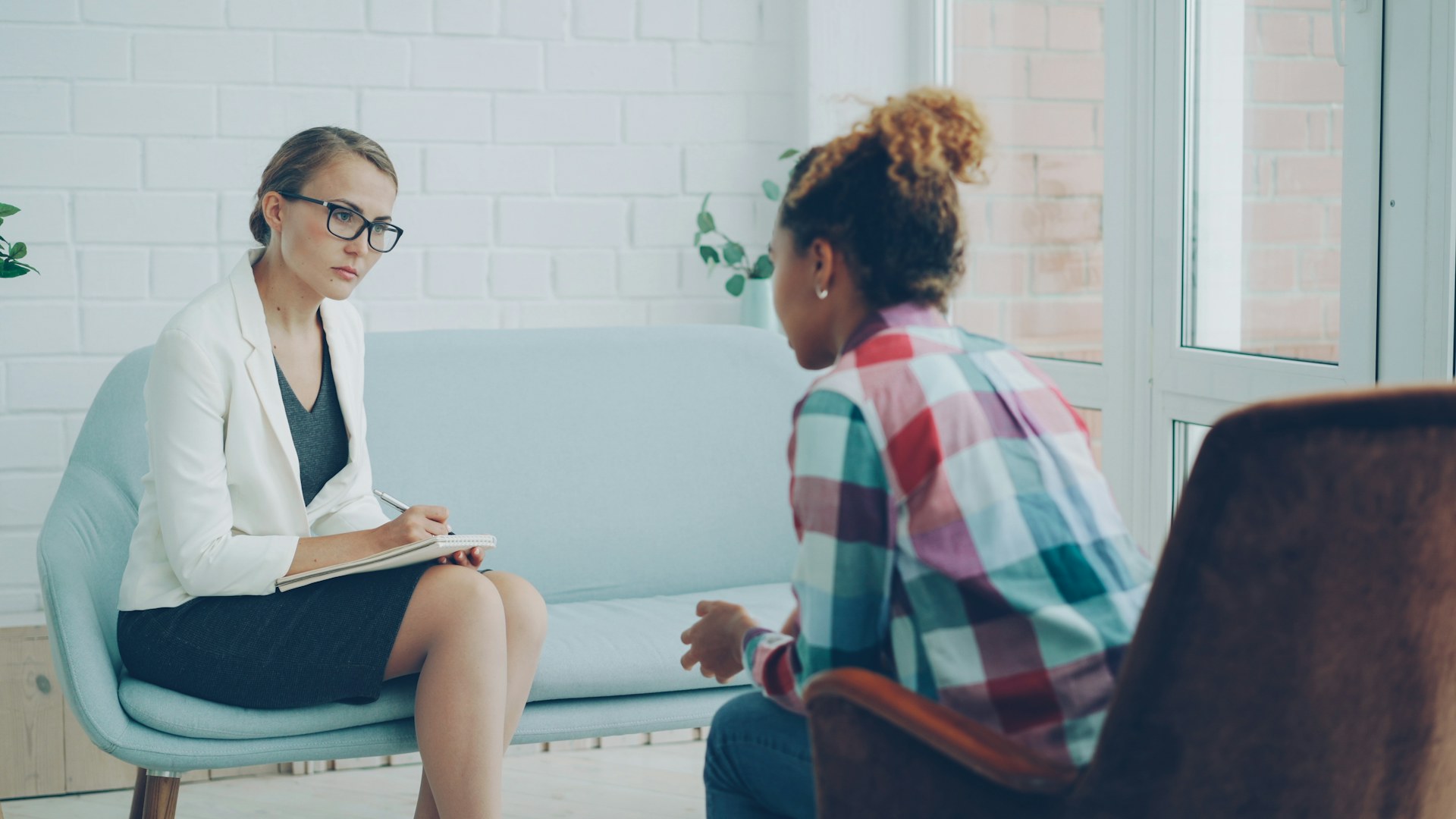 Mental health professional listening to a patient during a counseling session