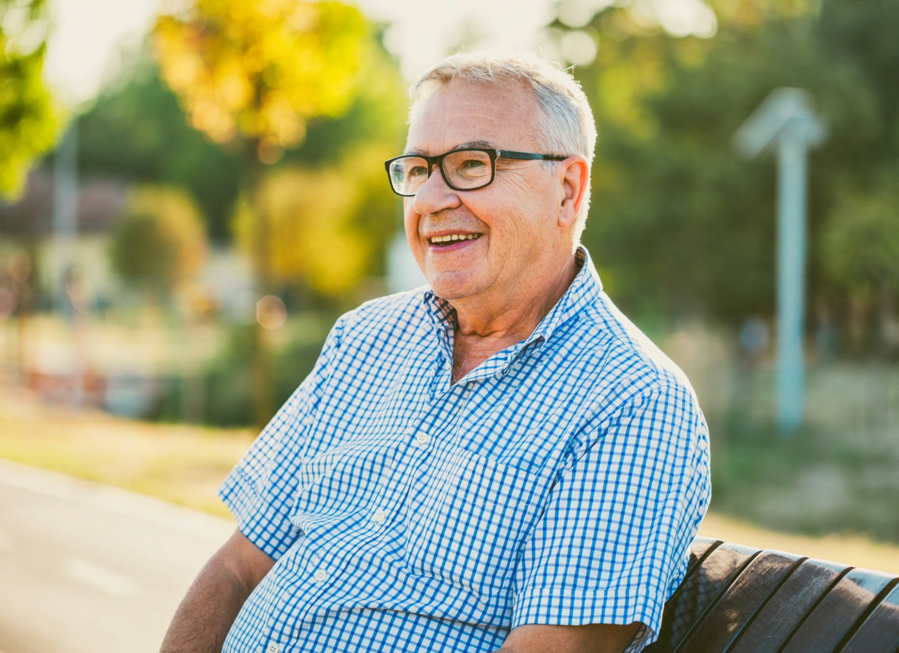 Smiling older man sitting on a bench