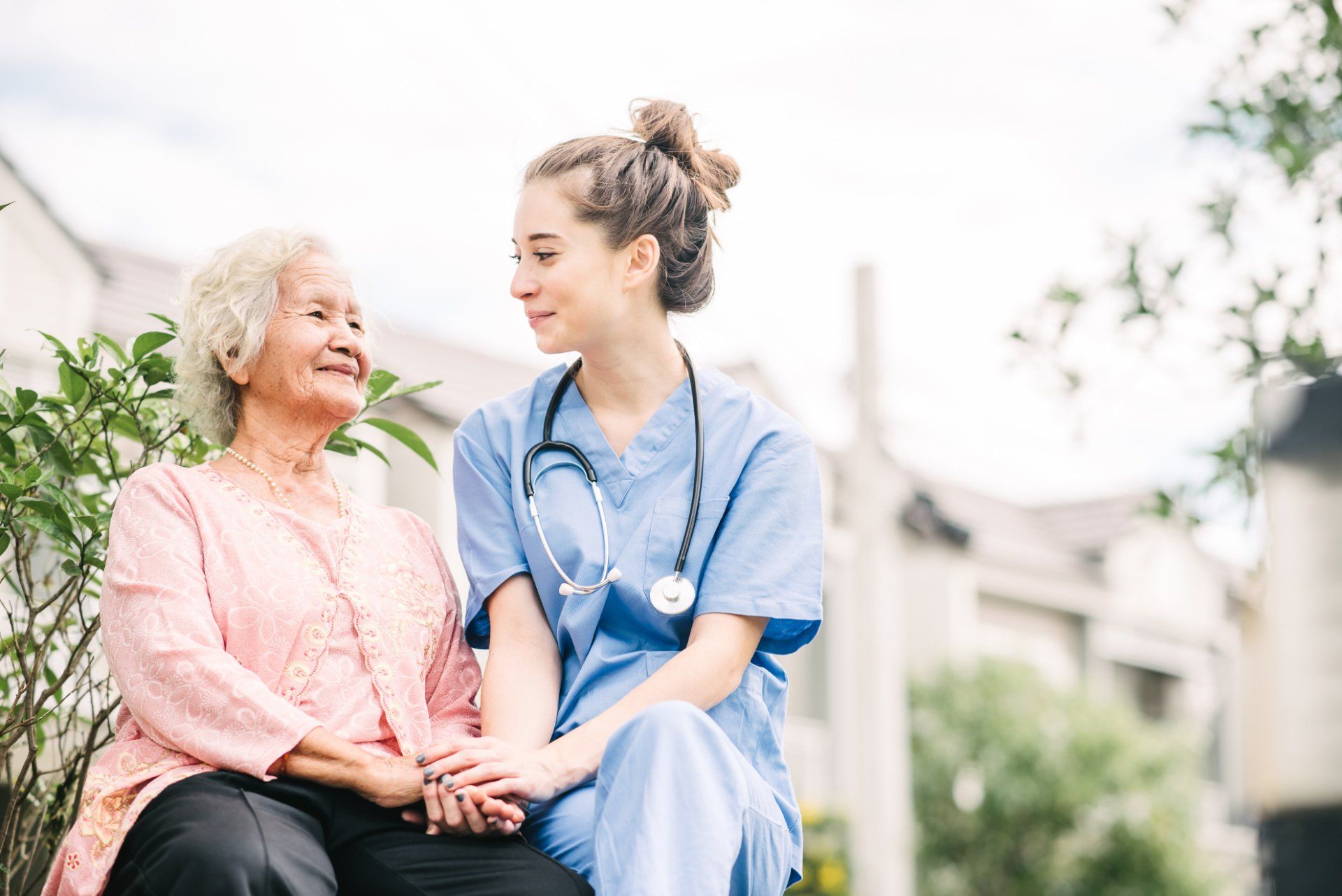 Nurse sitting outside with an older woman